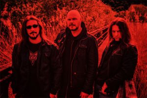 Red-tinted Disarmonia Mundi band photo wit Ettore Rigotti, Björn "Speed" Strid and claudio Ravinale